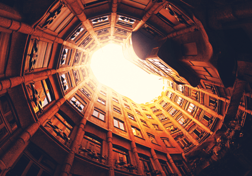 photo of spiral building from low angle with orange hue