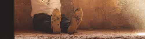 image of prisoner in dusty cell